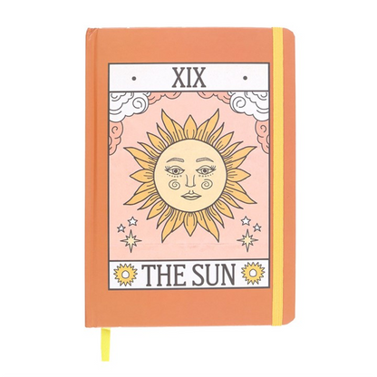 Notebook with 'The Sun' tarot card design on an orange cover