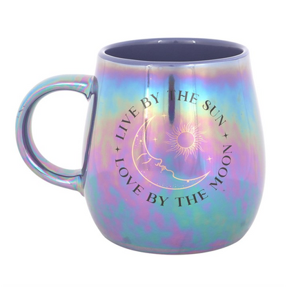 Iridescent mug with celestial design and text on a white background