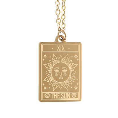 Gold necklace with a sun tarot design pendant on a white background
