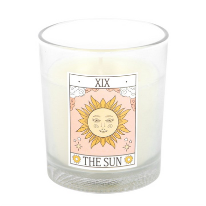 Candle with a 'The Sun' tarot card design on a white background