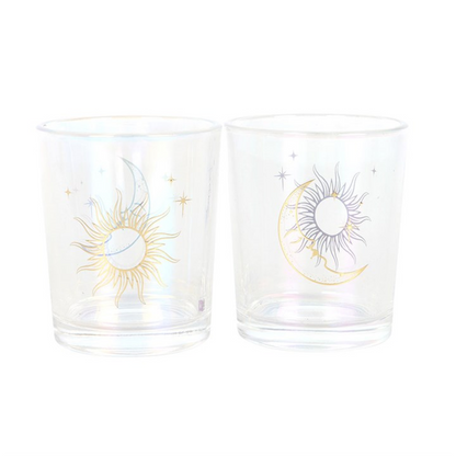 Two clear glasses with sun and moon designs on a white background
