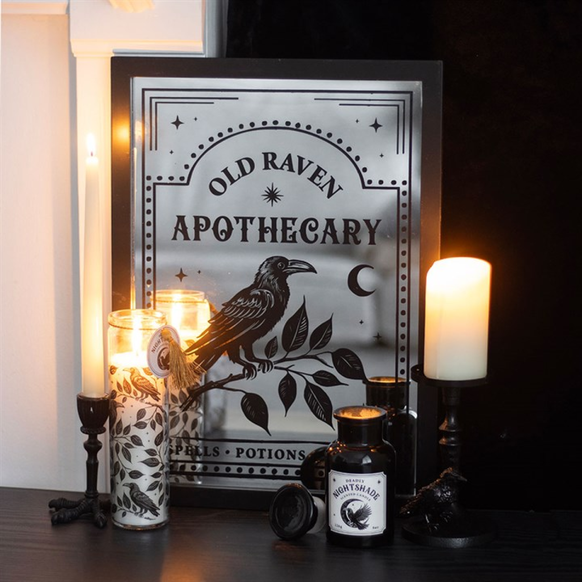 Decorative sign for 'Old Raven Apothecary' with candles and bottles on a dark surface.