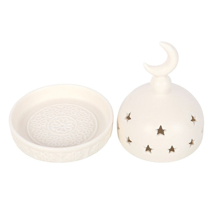 White ceramic dish with star patterns and a crescent moon ornament on a white background