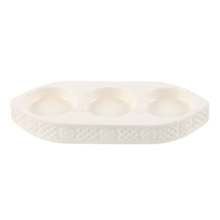 White ceramic dish with textured surface on a white background