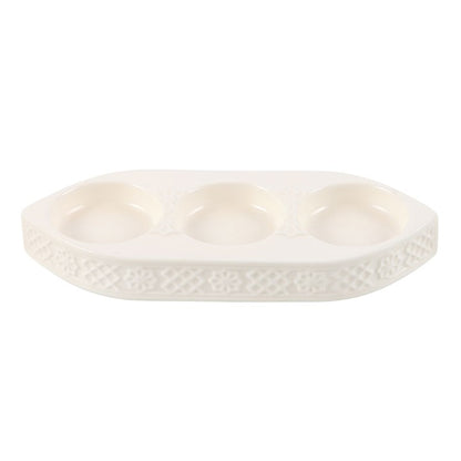 White ceramic dish with textured surface on a white background