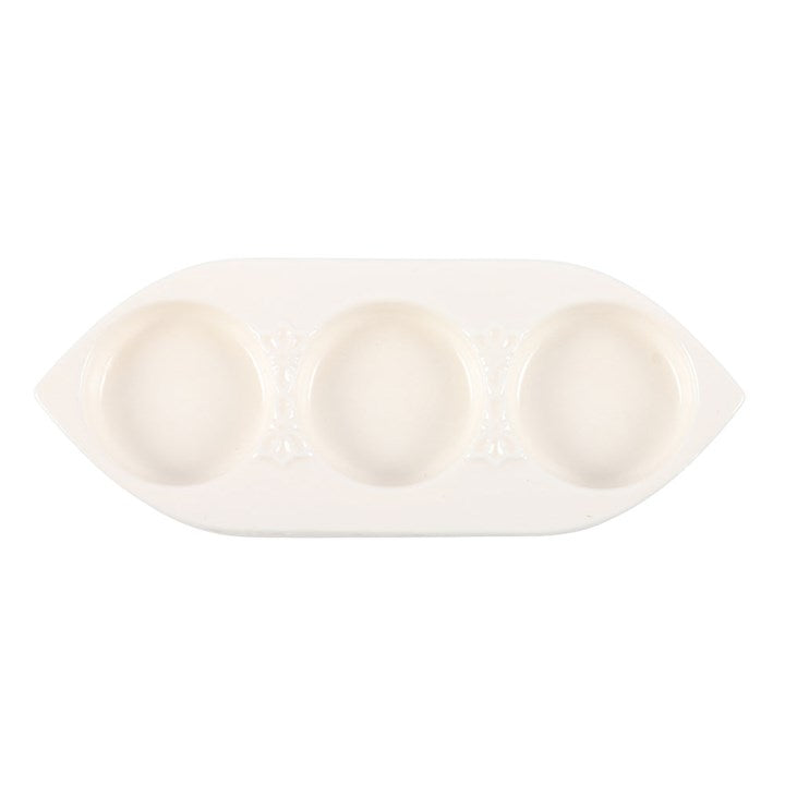 White ceramic dish with three compartments on a white background