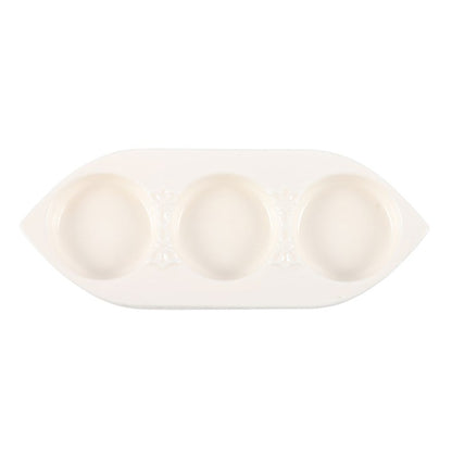 White ceramic dish with three compartments on a white background