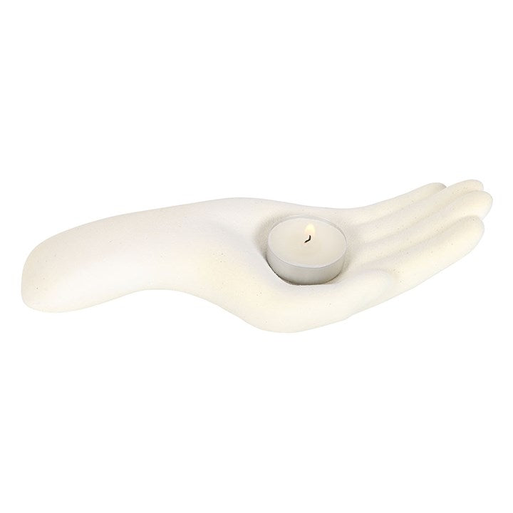 white candle holder in the shape of an open palm