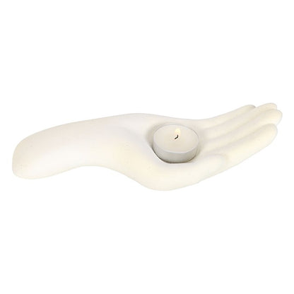 white candle holder in the shape of an open palm