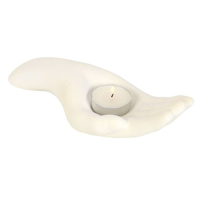 white candle holder in the shape of an open palm