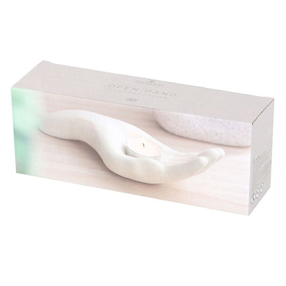 white candle holder in the shape of an open palm