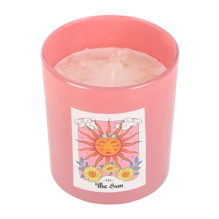Pink candle with a sun design and 'The Sun' label on a white background