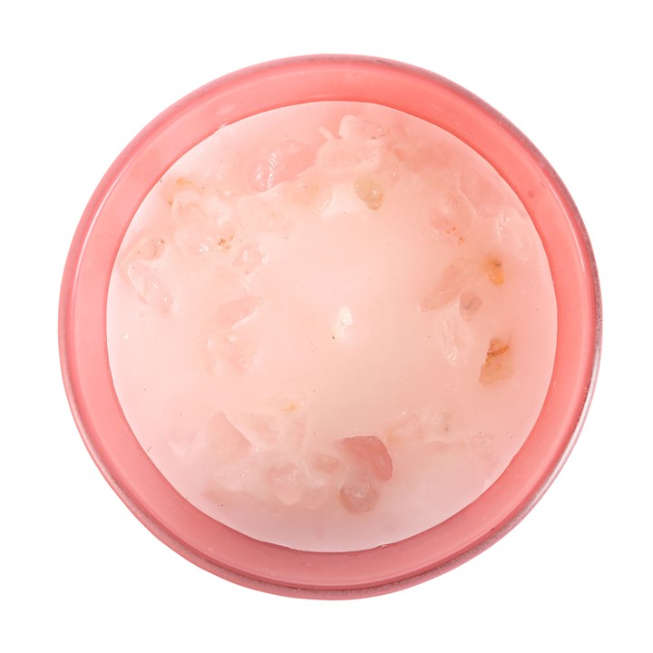 Pink container with a rose quartz inside on a white background