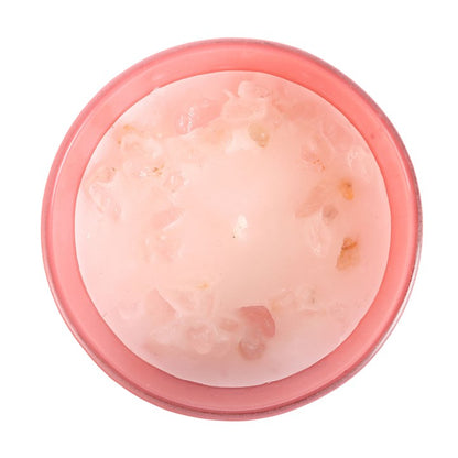 Pink container with a rose quartz inside on a white background