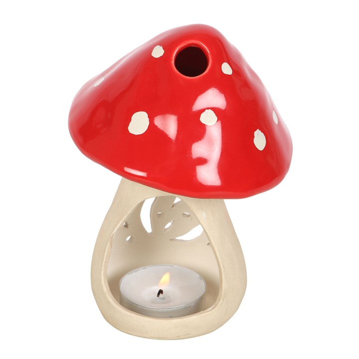 Mushroom-shaped candle holder with a red cap and beige stem on a white background