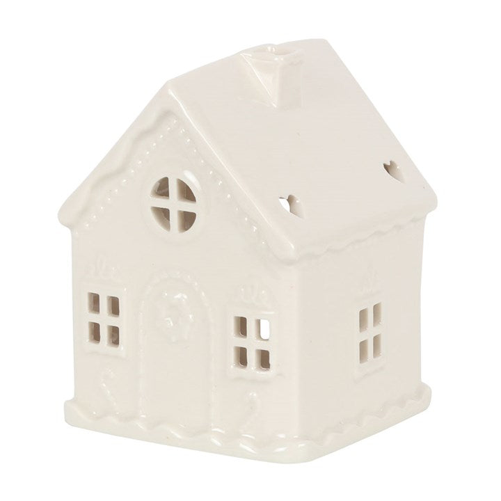 White cermaic candle holder in the shape of a house