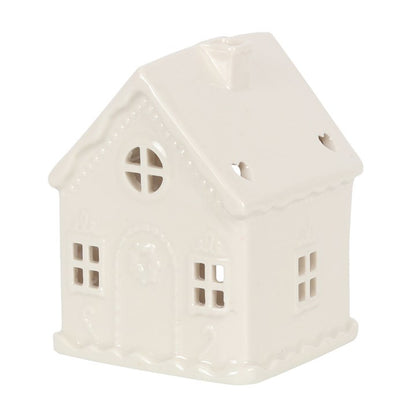 White cermaic candle holder in the shape of a house