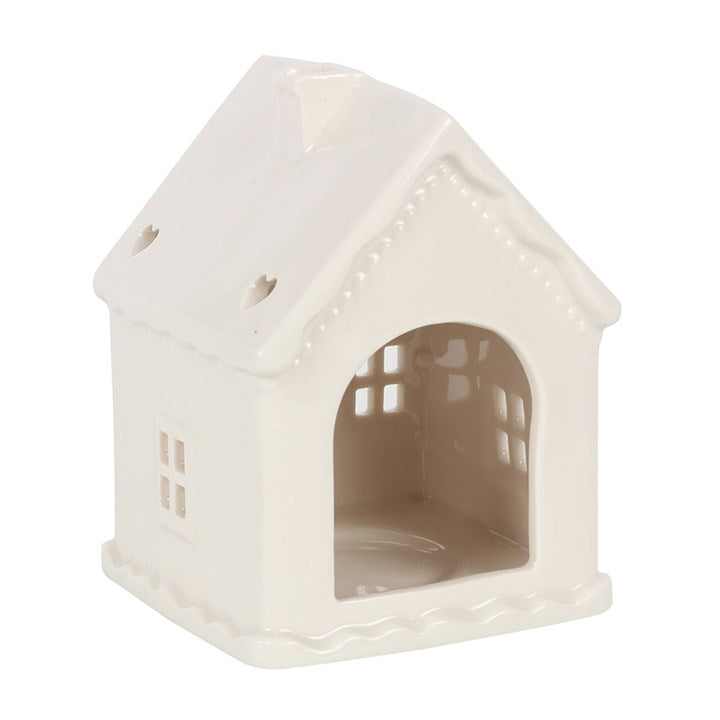White cermaic candle holder in the shape of a house