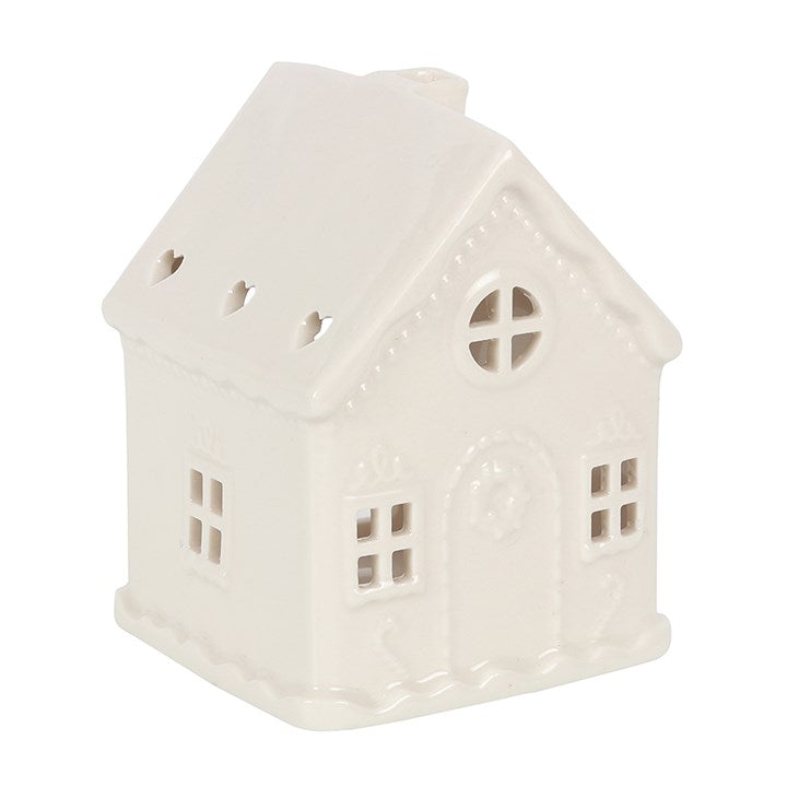 White cermaic candle holder in the shape of a house