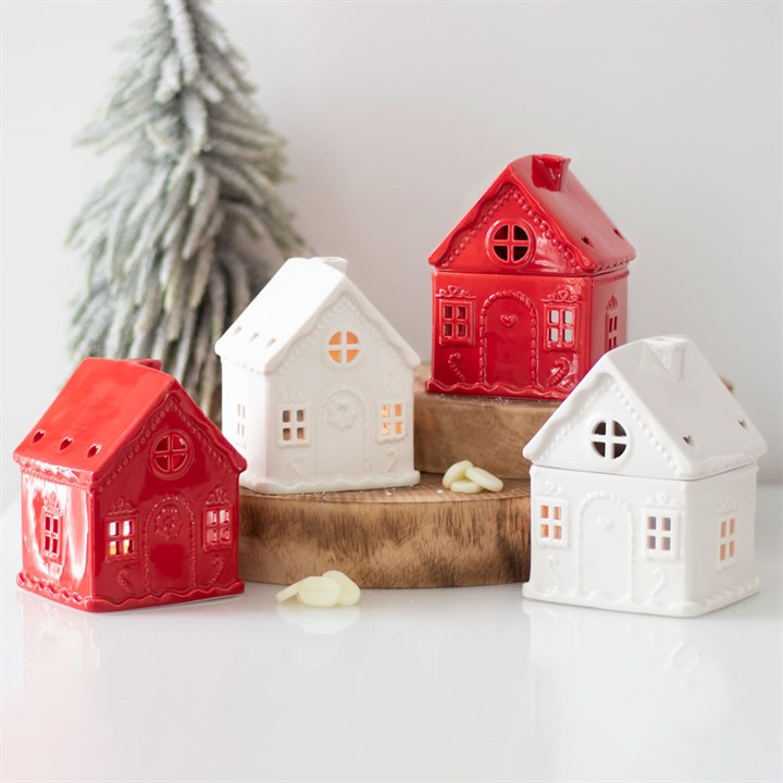 red & white hite cermaic candle holders in the shape of houses