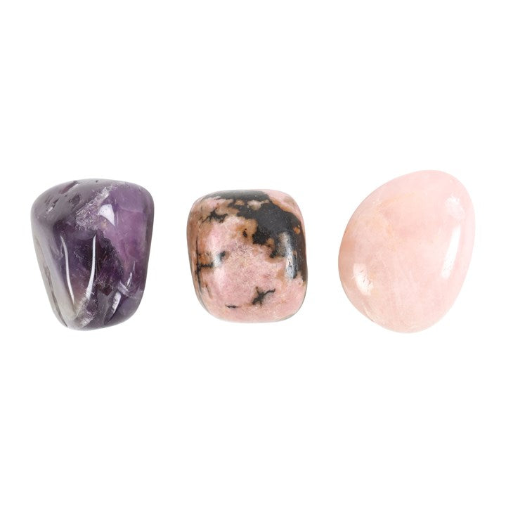 Three tumbled gemstones on a white background
