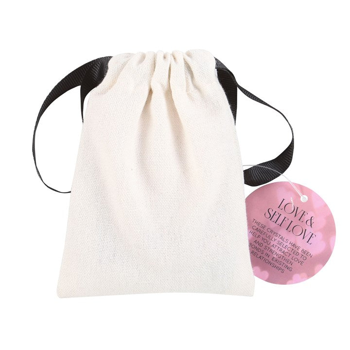 White drawstring bag with a pink heart-shaped product labeled 'Love & Self Love' on a white background