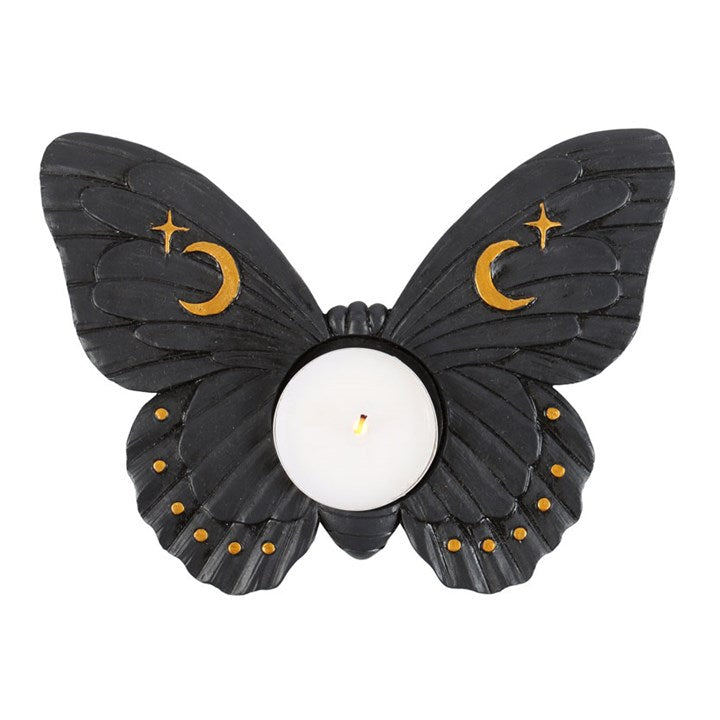 Butterfly-shaped candle holder with black wings and gold accents on a white background