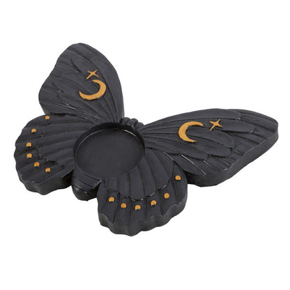 Black butterfly-shaped candle holder with gold accents on a white background