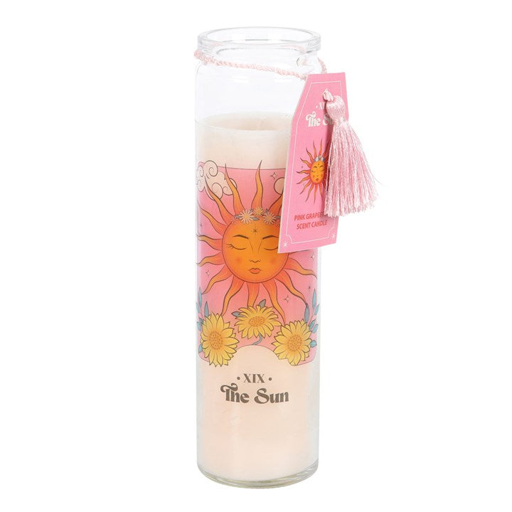 Candle with sun design and pink tag on a white background