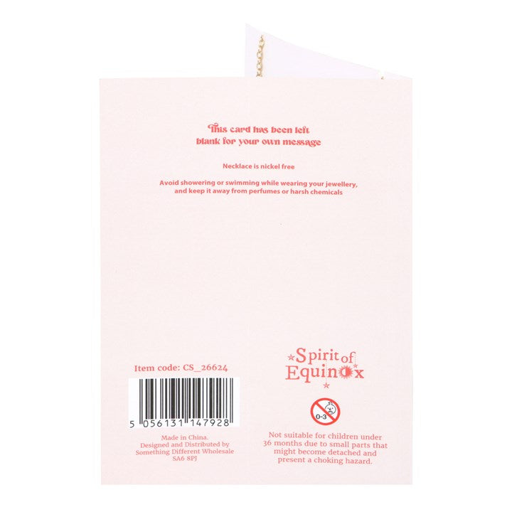 Back of a product packaging with text and branding on a light pink background