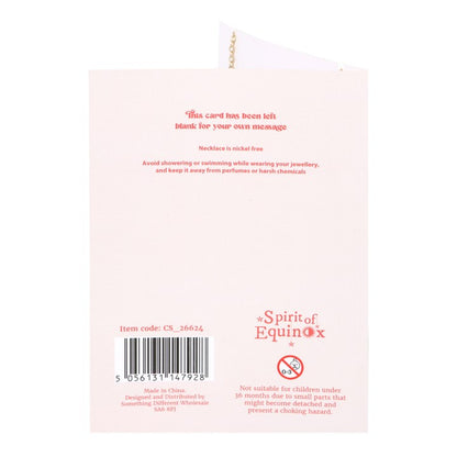 Back of a product packaging with text and branding on a light pink background