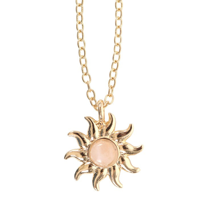 Gold sun-shaped pendant necklace with a rose quartz center on a white background