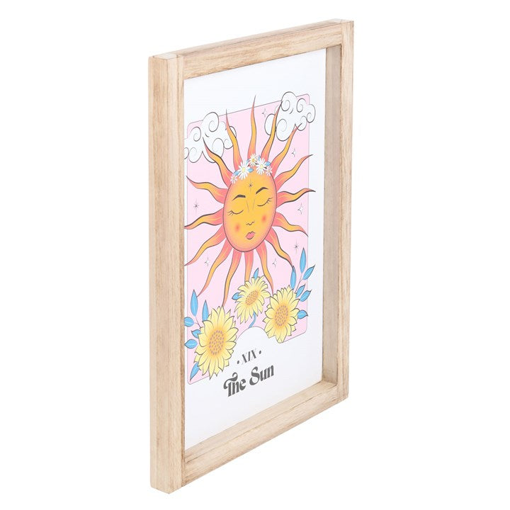 Framed artwork of a sun with flowers on a white background