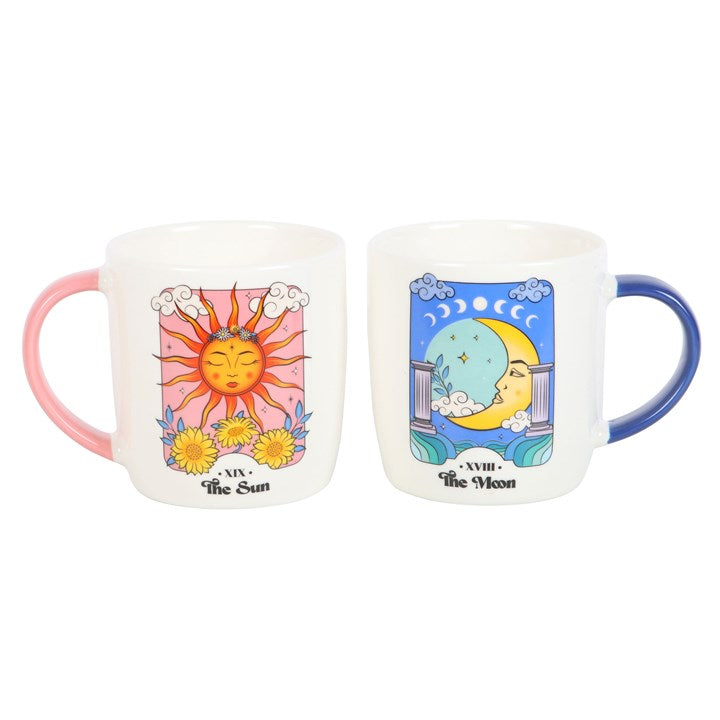 Two mugs with sun and moon designs on a white background