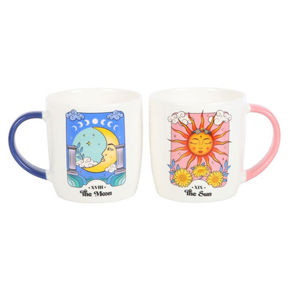 Two mugs with sun and moon designs on a white background