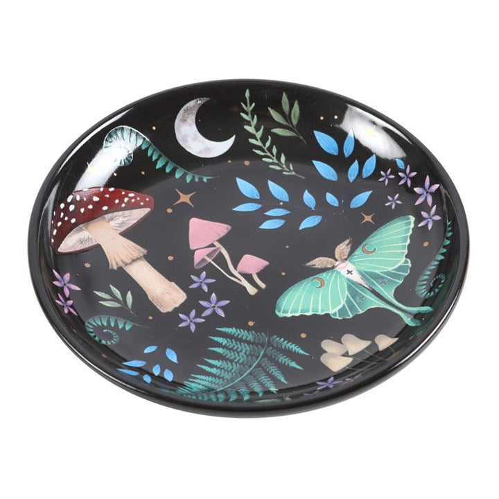 Decorative plate with fairy, mushrooms, and moon design on a black background