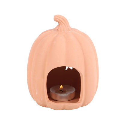 Ceramic pumpkin-shaped candle holder with a lit tealight on a white background