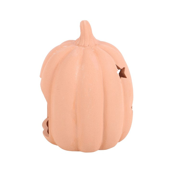 Peach-colored pumpkin with a small cutout on a white background