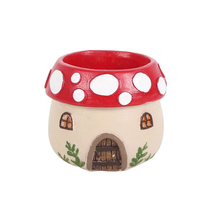Fairy house with red mushroom cap on a white background