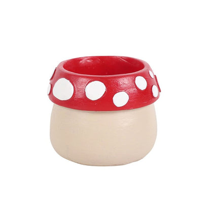 Ceramic container with red lid featuring white polka dots on a white background