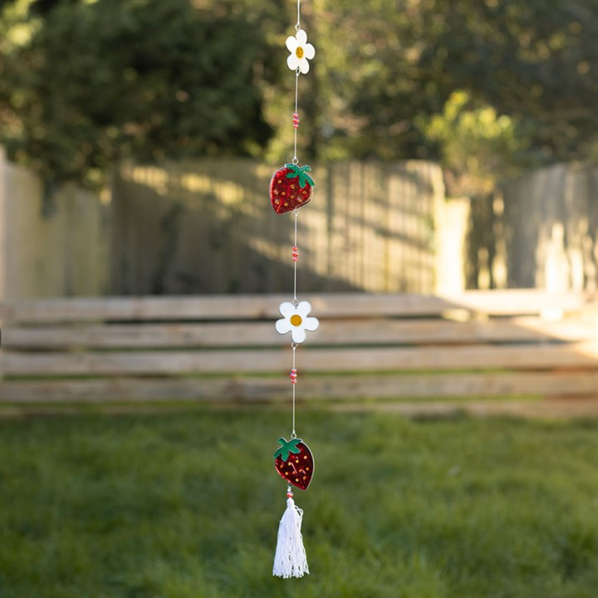 Strawberry and flower shaped suncatcher on a string of beads