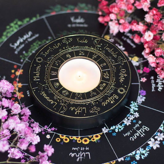 Black candle holer with wheel of the year design 